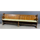 A 19th Century pine pew with plain crest rail slatted back on shaped end supports with trestle feet,