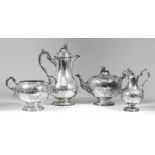 A Victorian Scottish harlequin silver four piece tea service, the domed covers with melon and leaf