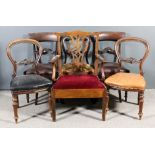 A pair of early Victorian mahogany dining chairs with plain curved crest rails and scroll carved