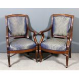 A pair of 19th Century French mahogany armchairs of "Empire" design, with arched and moulded crest