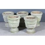 A set of five composition stone urn pattern garden planters on circular bases, each 16ins diameter x