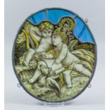 Two late 19th Century stained glass oval panels depicting winged cherubs at play and making music,