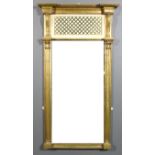 A 19th Century gilt framed pier glass with deep moulded cornice, on leaf carved scroll brackets,