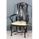 A mahogany armchair of "Queen Anne" design, with shaped crest rail, solid vase pattern splat,