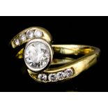 A modern 18ct gold mounted and diamond scroll pattern ring, set with central round cut stone (