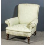 A late Victorian scroll back easy chair with outscroll arms upholstered in cream brocade, on