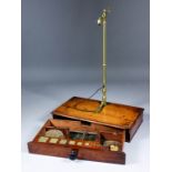 A mid-19th Century brass and steel apothecary scale in fitted mahogany case with weights, 14.5ins