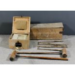 Two croquet sets, one set of iron hoops and other accessories, in fitted wooden box, and four