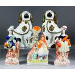 A pair of Victorian Staffordshire pottery seated spaniels, 10.5ins high, and three Staffordshire