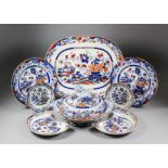 A Minton pottery part dinner service, transfer printed in blue and overpainted in colours with "