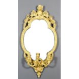 A late 19th Century gilt framed oval girandole with shell floral and scroll carved cresting and