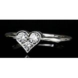 A platinum mounted diamond "heart" ring by Tiffany & Co, set with three diamonds (approximate