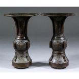 A pair of Chinese bronze Gu vases of archaistic form, with wide flared rim and spreading foot,