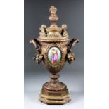 A pair of 19th Century French gilt brass urns and covers inset with oval porcelain plaques, the