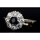 An 18ct gold sapphire and diamond mounted ring, set with central sapphire (approximately .25ct),