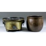 A Chinese dark patinated bronze circular two-handled censer with cast Kylin head pattern handles,