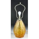 An amber moulded glass table lamp, moulded with leaf pattern and chrome mounted, 23ins high