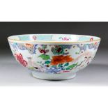 A Chinese porcelain "Famille Rose" bowl enamelled with chrysanthemum, prunus, rockwork and exotic
