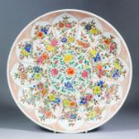 A Chinese "Famille Rose" porcelain saucer dish, enamelled with flowering branches within shaped