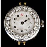 An early 20th Century lady's Rolex 18ct gold wristwatch with diamond bezel, the silvered dial with