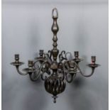 A bronzed metal six light chandelier, the knopped stem with bulbous open spiral pendant and six