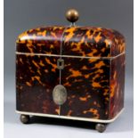 An early 19th Century tortoise shell rectangular two-division tea caddy, the domed top inlaid with