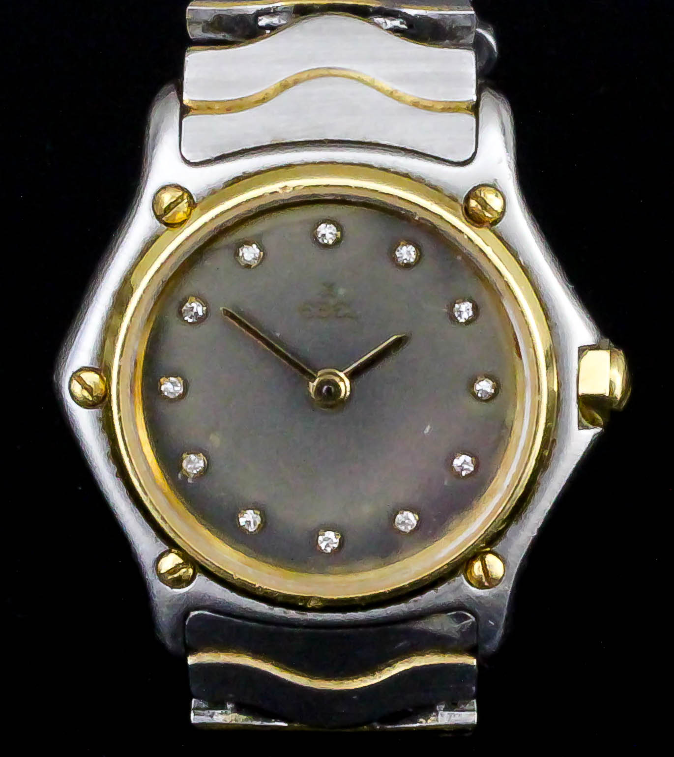 A lady's Ebel bi-metallic quartz wristwatch, Model No. 411493, the smoke coloured dial with