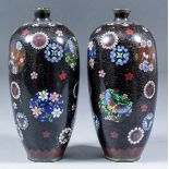 A pair of Japanese cloisonne enamel vases decorated with stylised flowers and butterflies within