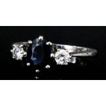 A platinum mounted sapphire and diamond three stone ring (approximate total diamond weight .70ct) (