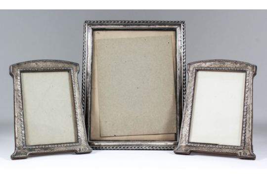 A pair of George V silver rectangular photograph frames with reeded and floral mounts (to hold