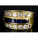 A modern gold coloured metal mounted sapphire and diamond triple band ring, the central band set