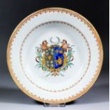 A Chinese Export armorial porcelain soup plate, the centre decorated in coloured enamels and gilt,