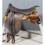 An early 20th Century British Army cavalry saddle with spare horseshoe pouch