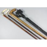 A late 19th Century malacca walking cane with silver top, with leaf decoration, 35.ins, a late