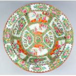 A Chinese "Cantonese" porcelain circular washbasin enamelled in colours with reserved panels of