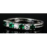 A platinum mounted emerald and diamond set ring by Tiffany & Co, set with four emeralds (