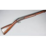 An 19th Century Indian percussion cap musket, the 58ins unmarked barrel with fluted muzzle, hardwood