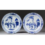 A pair of Chinese blue and white porcelain plates, painted with figures in a garden, the rim with