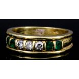 An 18ct diamond and emerald mounted ring, set with three small diamonds and four emeralds (size