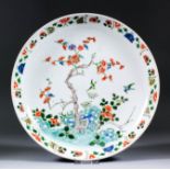 A Chinese porcelain circular dish, painted in the "Famille Vert" palette with birds amongst
