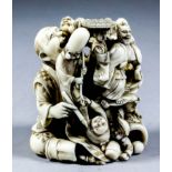 A Japanese carved ivory okimono of a parade group, including a kneeling figure of an artist with