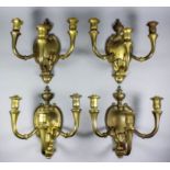 A set of four 20th Century gilt brass three-branch electric wall lights of "Baroque" design, 12.5ins