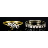 A modern 18ct white gold mounted and diamond half hoop eternity ring, set with eight small round