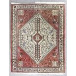 A Hereke rug woven in pastel colours with bold central hexagonal medallion with serrated borders,