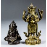 An Indian Hindi bronze figure of Ganesha seated on a circular throne in the form of Yogasana, his