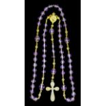 A gold coloured metal mounted and amethyst rosary, set with amethyst beads (approximately 50ct)