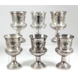 A set of six Victorian silver goblets, the cylindrical bodies with bulbous bases and embossed with