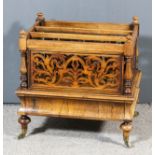 A Victorian rosewood three-division Canterbury with fretted side panels and spindle turn