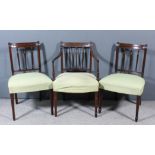 Three George III mahogany dining chairs (including one armchair) with narrow panelled crest rails