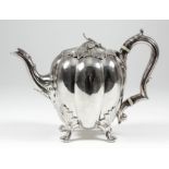 A good William IV silver melon shaped teapot, the leaf pattern lid with leaf finial, with leaf